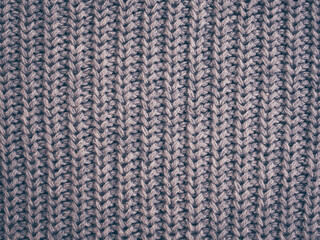 Grey knitted texture, dark fabric background. Vinrage color , trends fashion. Woolen sweater, backdrop clothing.