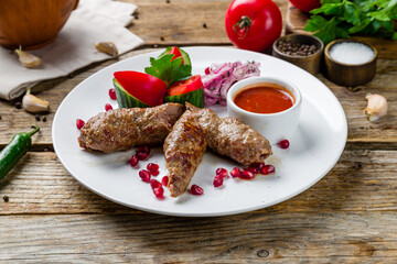 Lamb Lula kebab on old wooden table