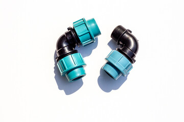 black coupling for connecting plastic pipes on a white background. Residential water supply
