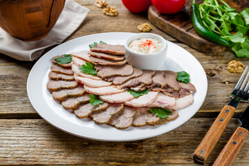 slicing of different meat on old wooden table