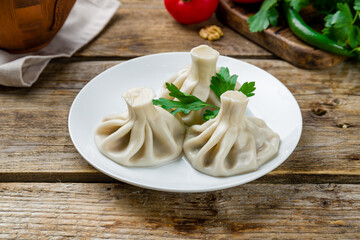 Khinkali with lamb, Georgian kitchen on old wooden table