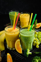 Smoothies. Smoothies of vegetables and fruits. Healthy drinks. Top view. On a black background.