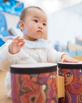 babygirl playing drums