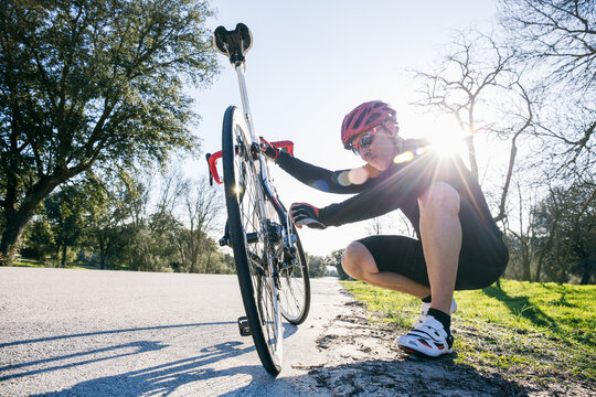 Man reparing a bicycle in Madrid, Spain