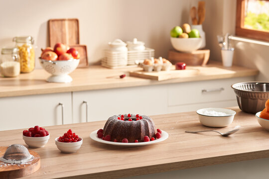 Cake and cooking ingredients in kitchen