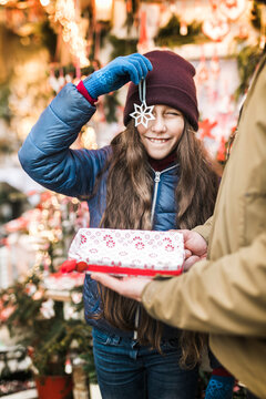 Girl posing with a porcelain snowflake at the Christmas market