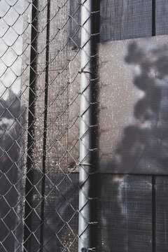Chain link fence against brick wall