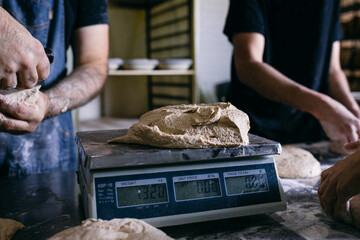 Baker weighing dough on scales