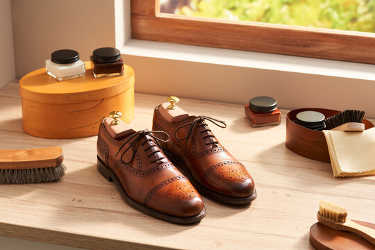 Brogue shoes and cleaning tools near window