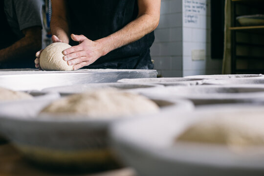 Baker preparing bread dough for baking