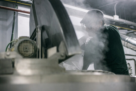 Man watching brewing process on factory