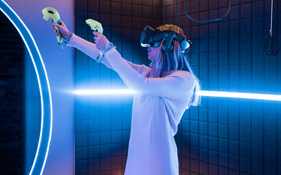 Woman enjoying vr gaming in an indoor arcade