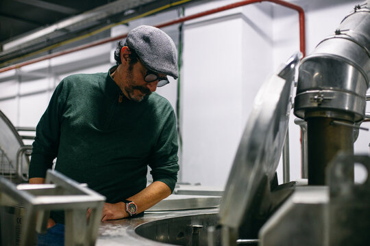 Man watching brewing process on factory