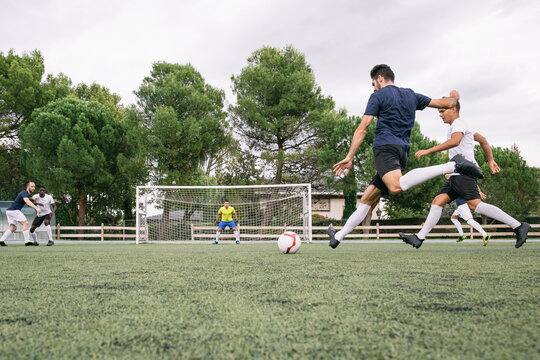 Fototapeta Soccer player kicking a ball during a soccer match