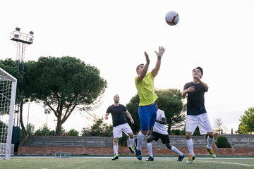 players playing soccer at sunset