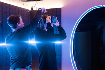 Man adjusting VR headset on a man's head