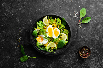 Diet food. Boiled vegetables and boiled egg in a frying pan. Rustic style. Top view. Free space for your text.