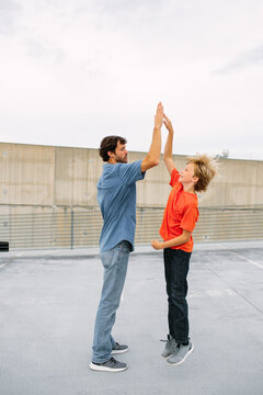 Preteen Son Giving Dad High Five