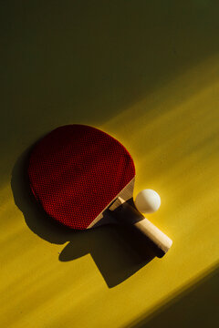 A Racket And Ping Pong On A Yellow Background