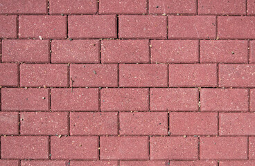Background of red paving slabs stones, brick wall close up