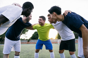 Football team standing together and smiling before match.
