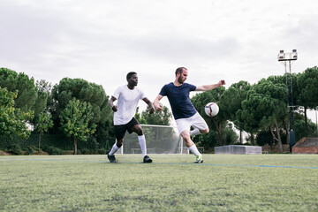 Group of men playing football on field