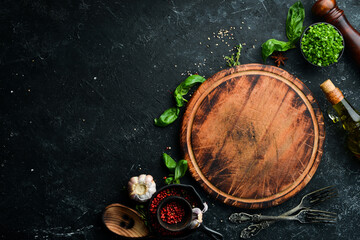 Black stone culinary background with vegetables and spices. Top view. Rustic style.