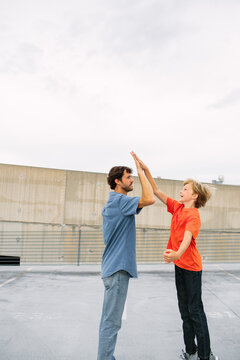 Preteen Son Giving Dad High Five