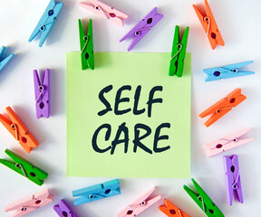 Sekf care different-colored clothespins boost the mood and hold a leaf with the inscription