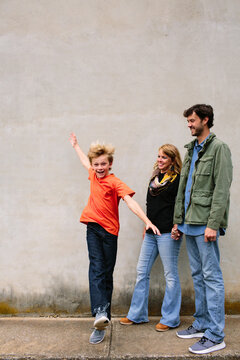 Mom and Dad Watching Preteen Son Jump