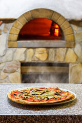 italian pizza in front of a wood stove