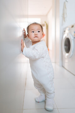 baby playing washing machine at home