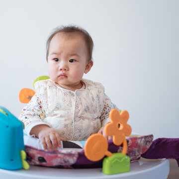 Babygirl playing at the game table bouncing bed