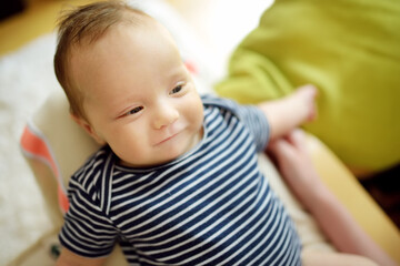 Cute three months old baby boy playing with his mommy.