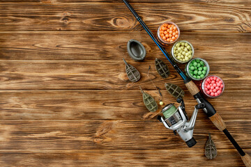 Accessories for carp fishing and fishing baits on wooden planks with copy space