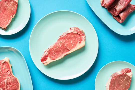 Plates with pieces of raw meat