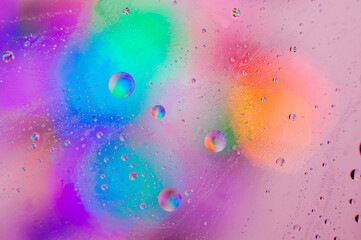 Iridescent macro background of oil drops on the water