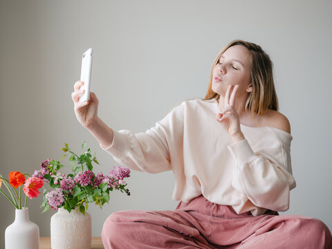Woman taking selfies with phone