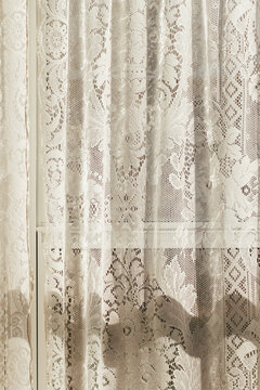 Morning sun through lace curtain