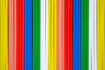 top view of multi coloured  plastic  drinking straws in a row