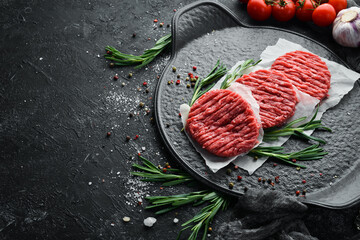 Raw cutlets for a burger with spices. Meat. Top view. Free space for your text.