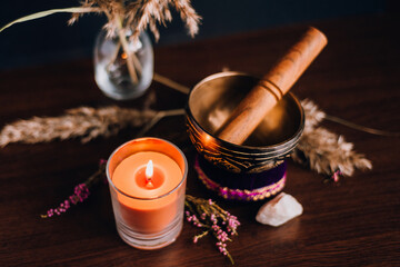 spa still life with candle, crystal and singing bowl for meditation