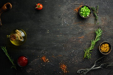 Dark cooking banner. Vegetables and spices on the kitchen table. Top view. Free space for your text.