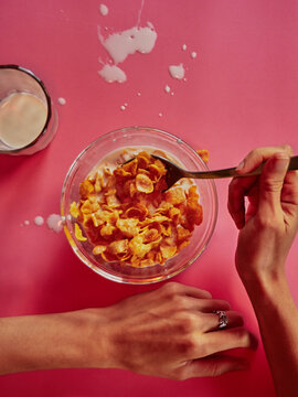 Corn flakes with milk breakfast meal on pink