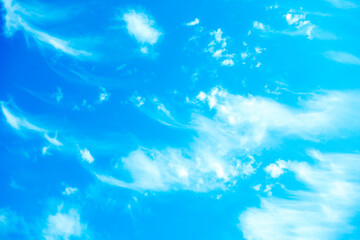 Fototapeta na wymiar Blue sky background with white fluffy clouds