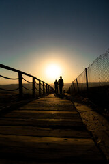 Obraz premium silhouette of a person walking on the pier