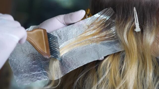 hair being careful painted  and wrapped in foil.