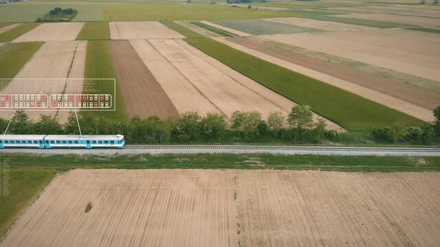 A train running on track amidst fields with animation of seating capacity and reservation of seats. Motion graphics.