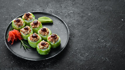 Green Sushi rolls - with eel fish and green Tobiko caviar. Pieces of delicious sushi. Top view.
