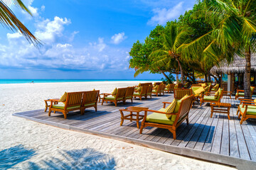 Wooden table and chairs by the tropical warm sea. Maldives